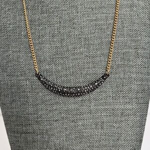 Sparkling crescent pendant on gold tone chain